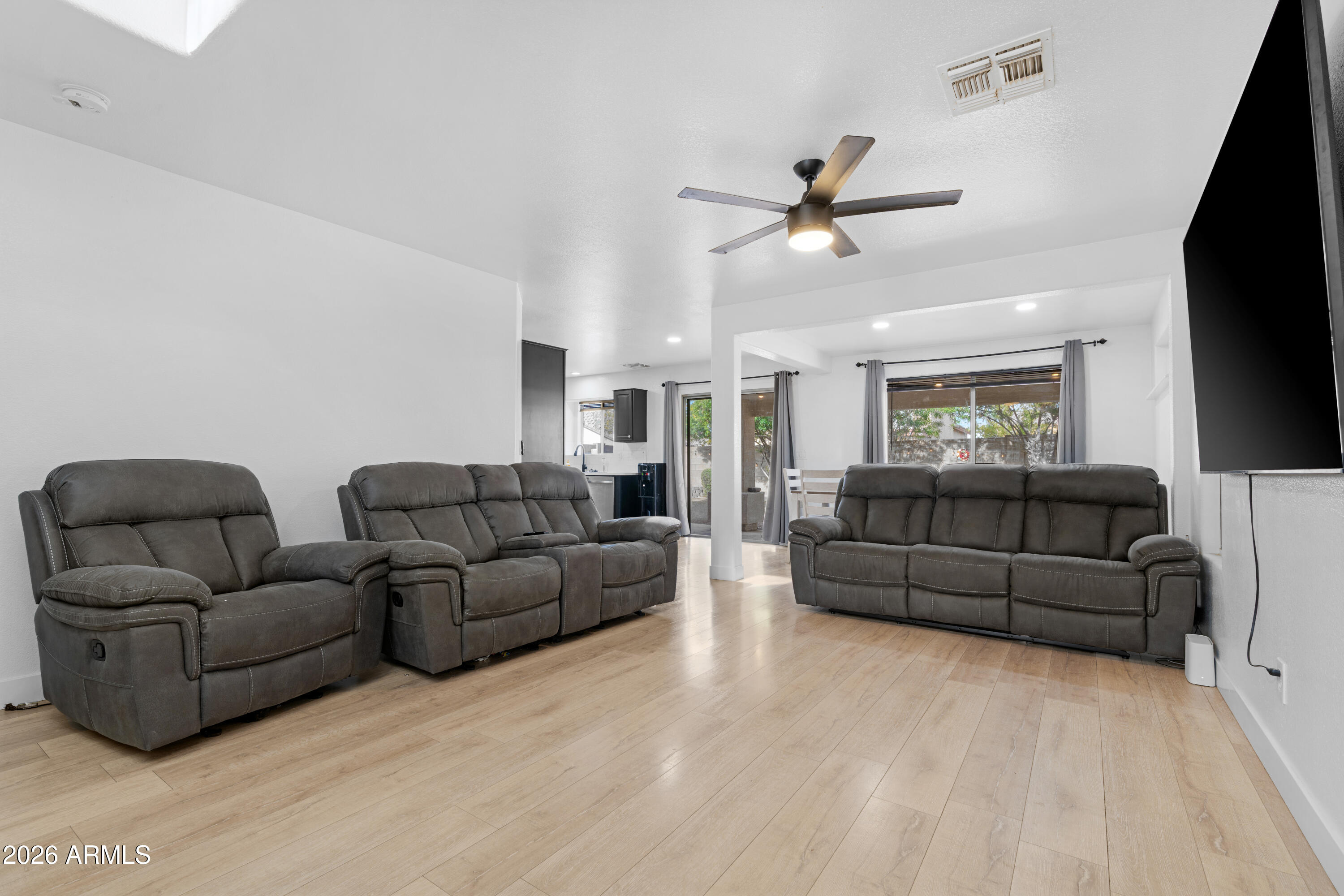 1810 East Milky Way Gilbert, AZ 85295 - Photo 6 of 46 a living room with furniture ceiling fan and a rug
