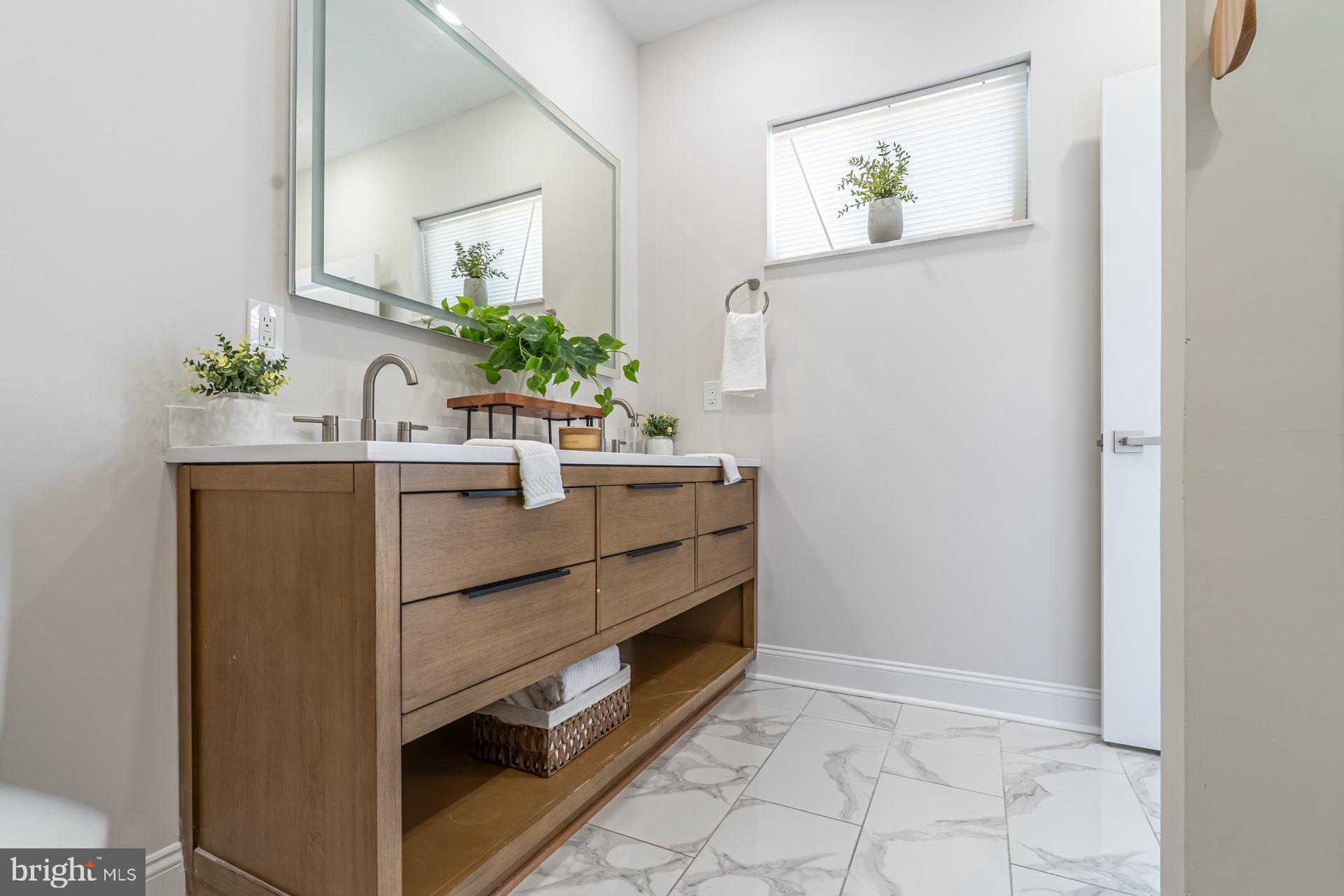1636 South 2nd Street Philadelphia, PA 19148 - Photo 25 of 39 a room that has a sink and a mirror in it
