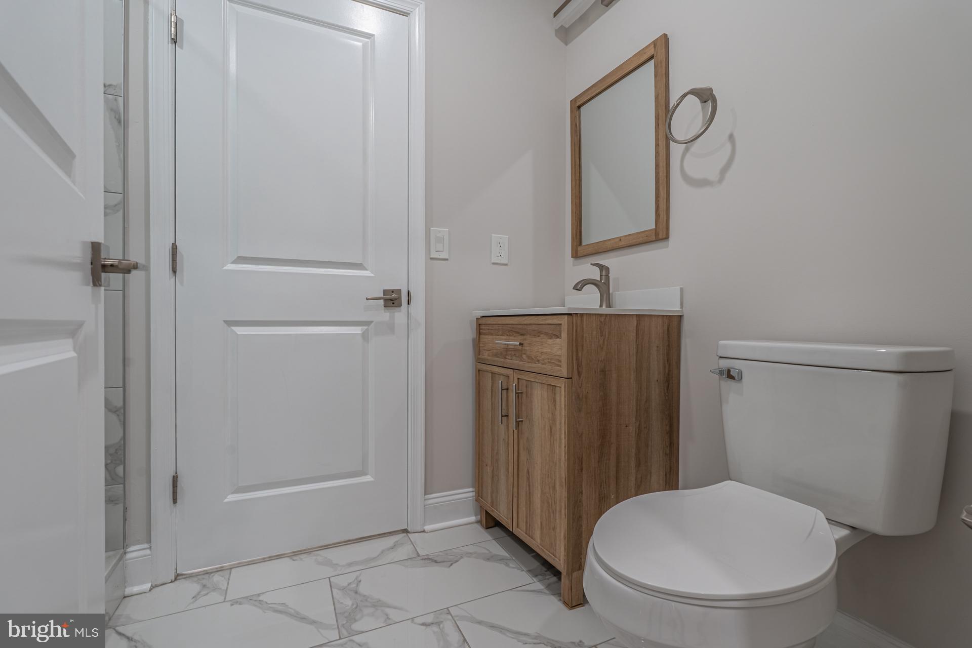 1636 South 2nd Street Philadelphia, PA 19148 - Photo 34 of 39 a bathroom with a toilet and a mirror
