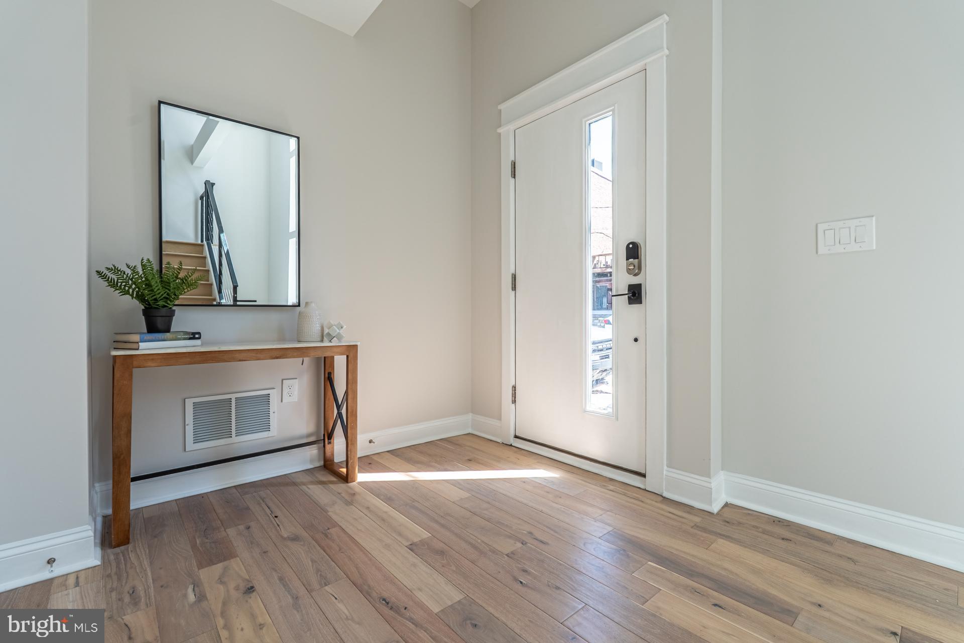 1636 South 2nd Street Philadelphia, PA 19148 - Photo 5 of 39 a view of an empty room with wooden floor and a fireplace