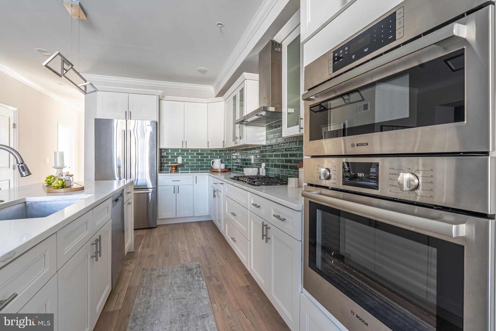 1636 South 2nd Street Philadelphia, PA 19148 - Photo 7 of 39 a kitchen with stainless steel appliances a stove microwave and cabinets