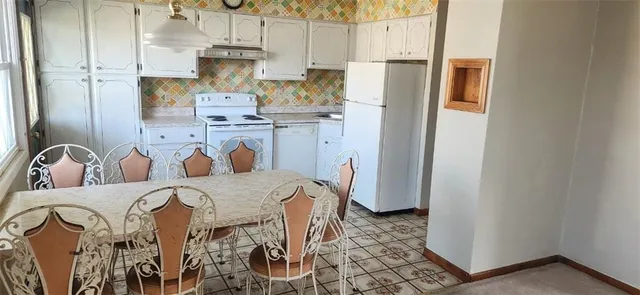 a kitchen with stainless steel appliances granite countertop a refrigerator and a stove