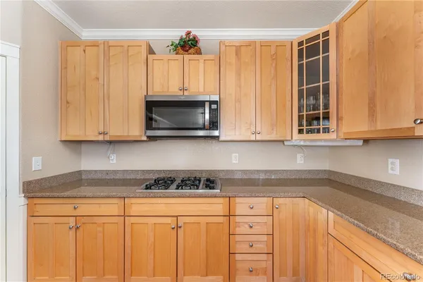 a kitchen with stainless steel appliances granite countertop white cabinets and a sink