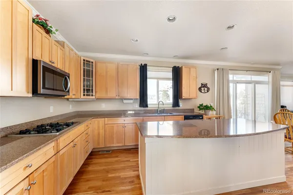 a kitchen with stainless steel appliances granite countertop a stove and a sink