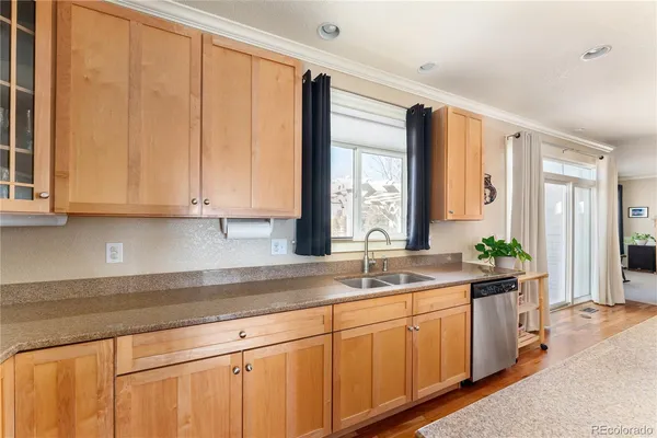 a kitchen with stainless steel appliances granite countertop white cabinets and a sink