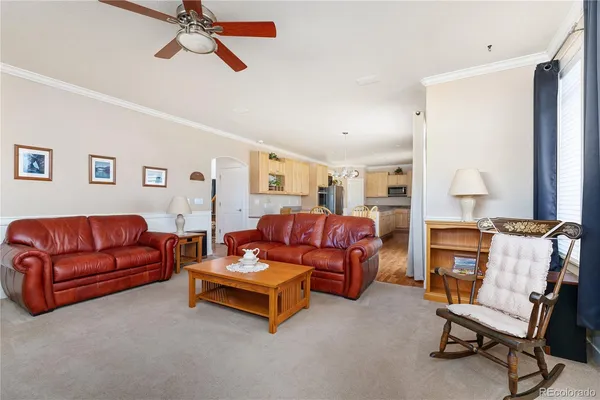 a living room with furniture and a dining table with projector kitchen