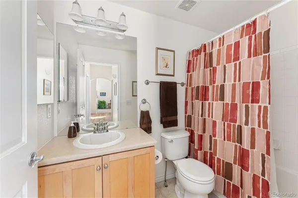 a bathroom with a sink a toilet a shower and a mirror