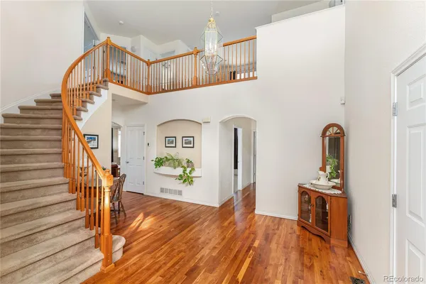 a view of entryway and hall with wooden floor
