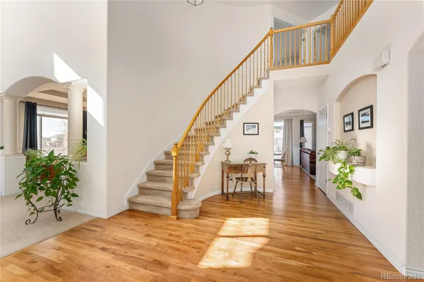 a view of entryway and hall with wooden floor