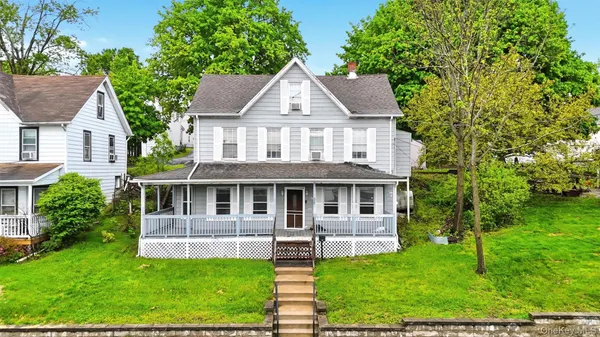 a front view of a house with a yard table and chairs