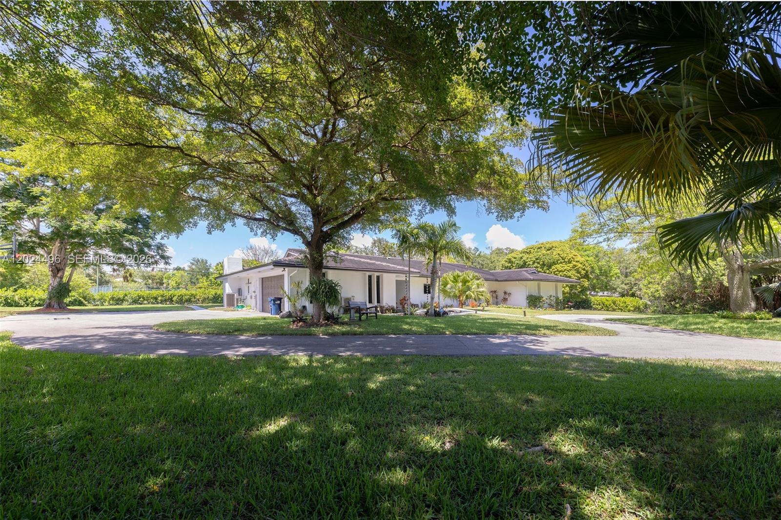 6875 North Cartee Road Palmetto Bay, FL 33158 - Photo 3 of 42 a house view with outdoor space and trees