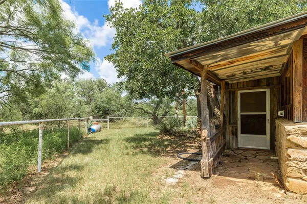 a backyard of a house with yard and outdoor seating