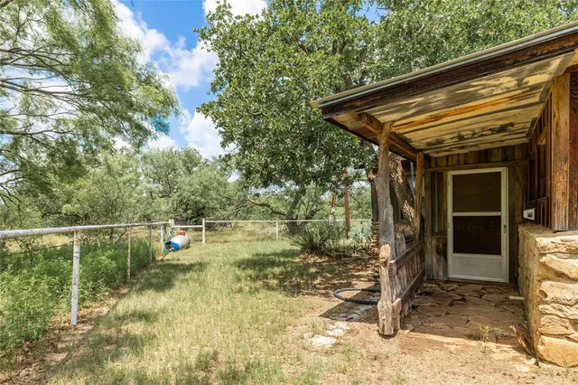 a backyard of a house with yard and outdoor seating