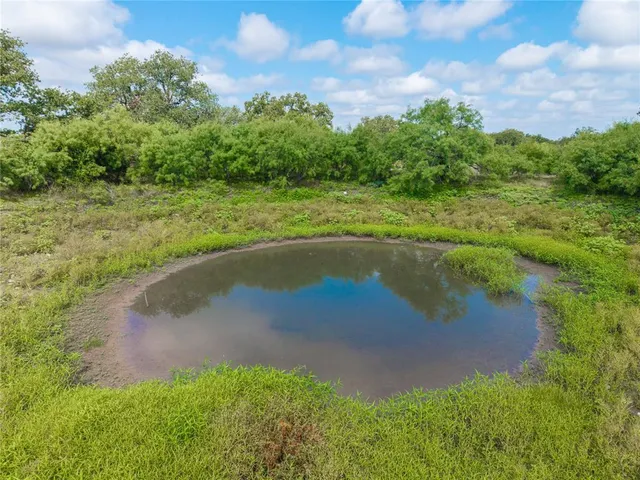 a view of a field with an ocean beach