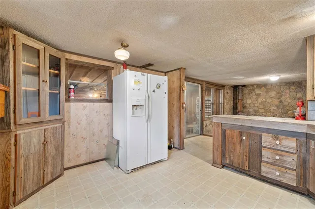 a view of kitchen with stainless steel appliances granite countertop cabinets and window