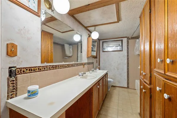 a bathroom with a sink a mirror and a shower