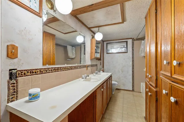 a bathroom with a sink a mirror and a shower