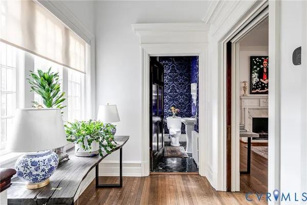 a living room with fireplace furniture and a chandelier