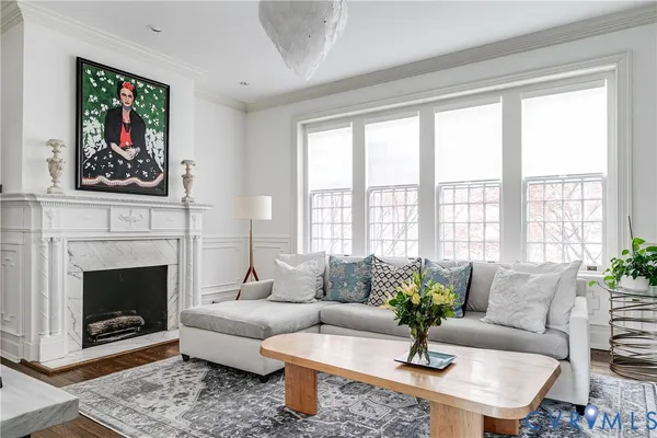 a living room with furniture and a fireplace