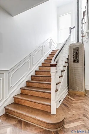a living room with furniture a fireplace and a large window
