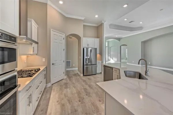 a kitchen with counter top space cabinets and stainless steel appliances