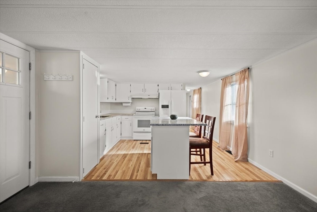 199 Windswept Road Wareham, MA 02571 - Photo 11 of 29 a living room with stainless steel appliances granite countertop furniture wooden floor and a window