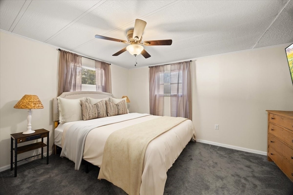 199 Windswept Road Wareham, MA 02571 - Photo 19 of 30 a bedroom with a bed and a chandelier