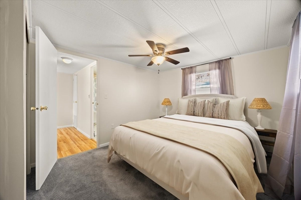 199 Windswept Road Wareham, MA 02571 - Photo 20 of 30 a bedroom with a bed and a chandelier