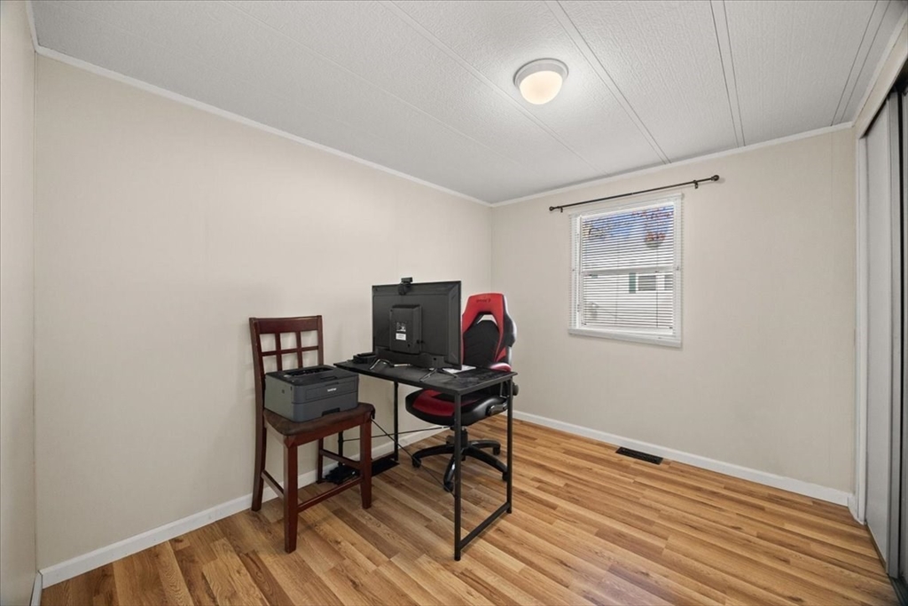 199 Windswept Road Wareham, MA 02571 - Photo 21 of 30 a view of a workspace with furniture and wooden floor