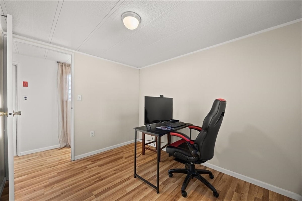 199 Windswept Road Wareham, MA 02571 - Photo 22 of 30 a view of a workspace with furniture and wooden floor