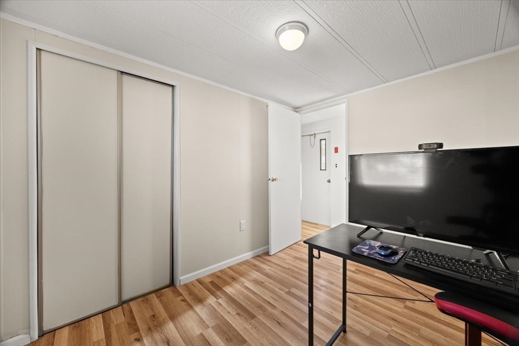 199 Windswept Road Wareham, MA 02571 - Photo 23 of 30 a room with wooden floor and flat screen tv