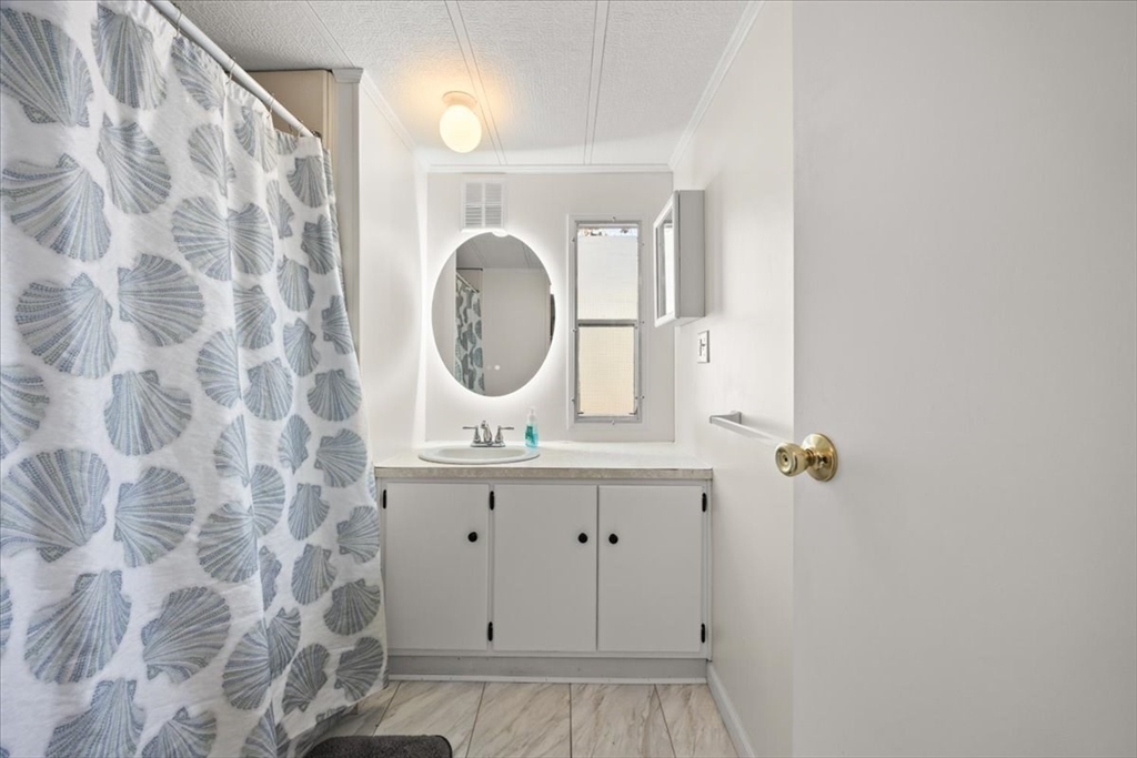 199 Windswept Road Wareham, MA 02571 - Photo 23 of 29 a bathroom with a sink and a mirror