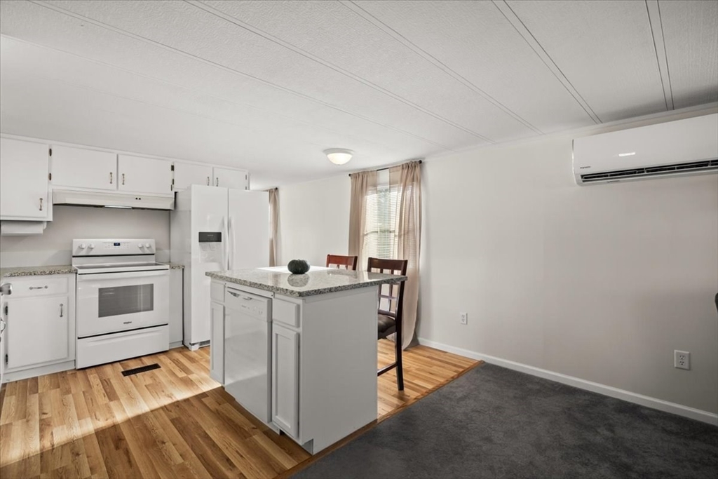199 Windswept Road Wareham, MA 02571 - Photo 8 of 30 a kitchen with white cabinets and white appliances