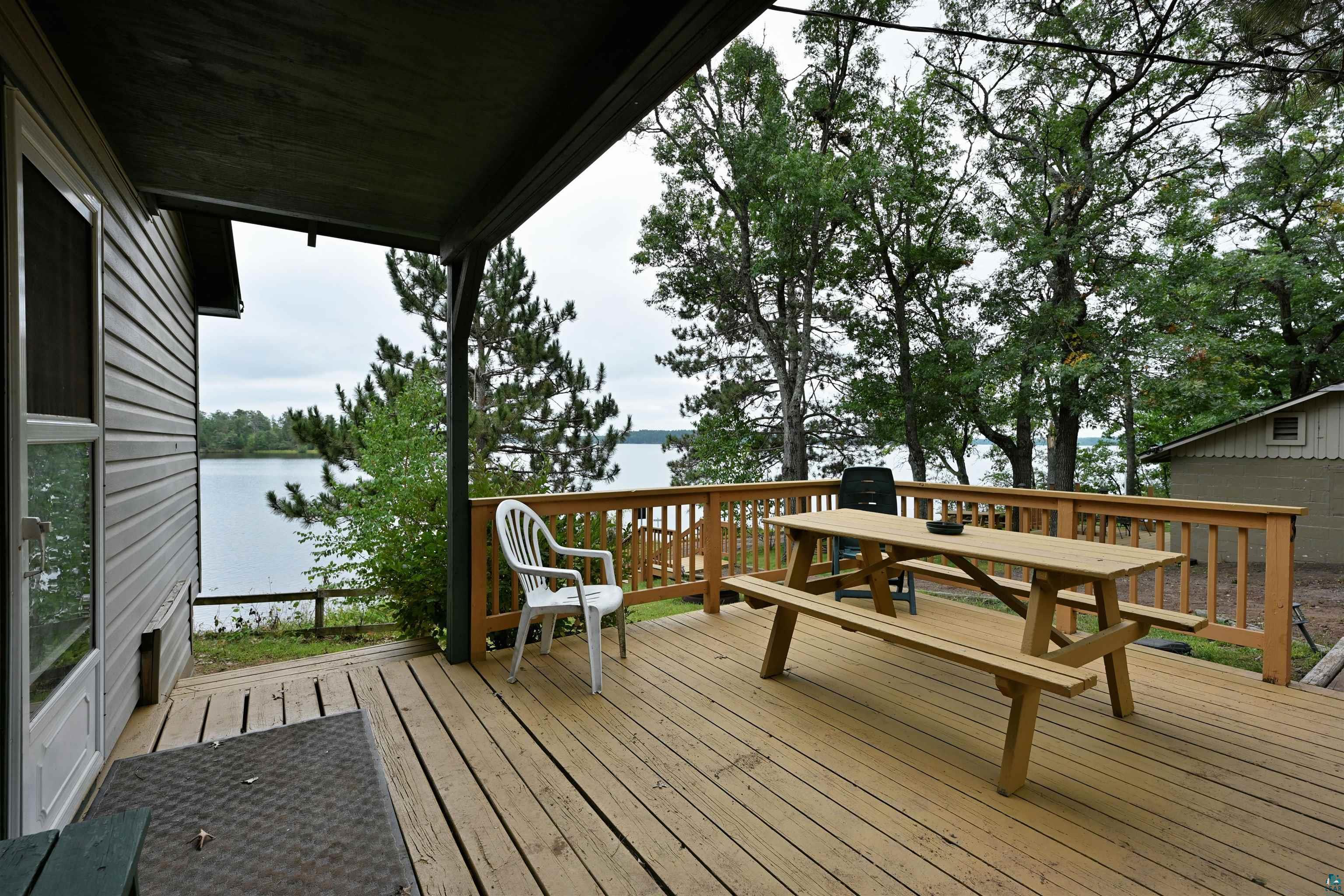 6833 View Point Lodge Road, Unit 14 Gordon, WI 54838 - Photo 11 of 34 Wooden deck with a water view and outdoor dining area