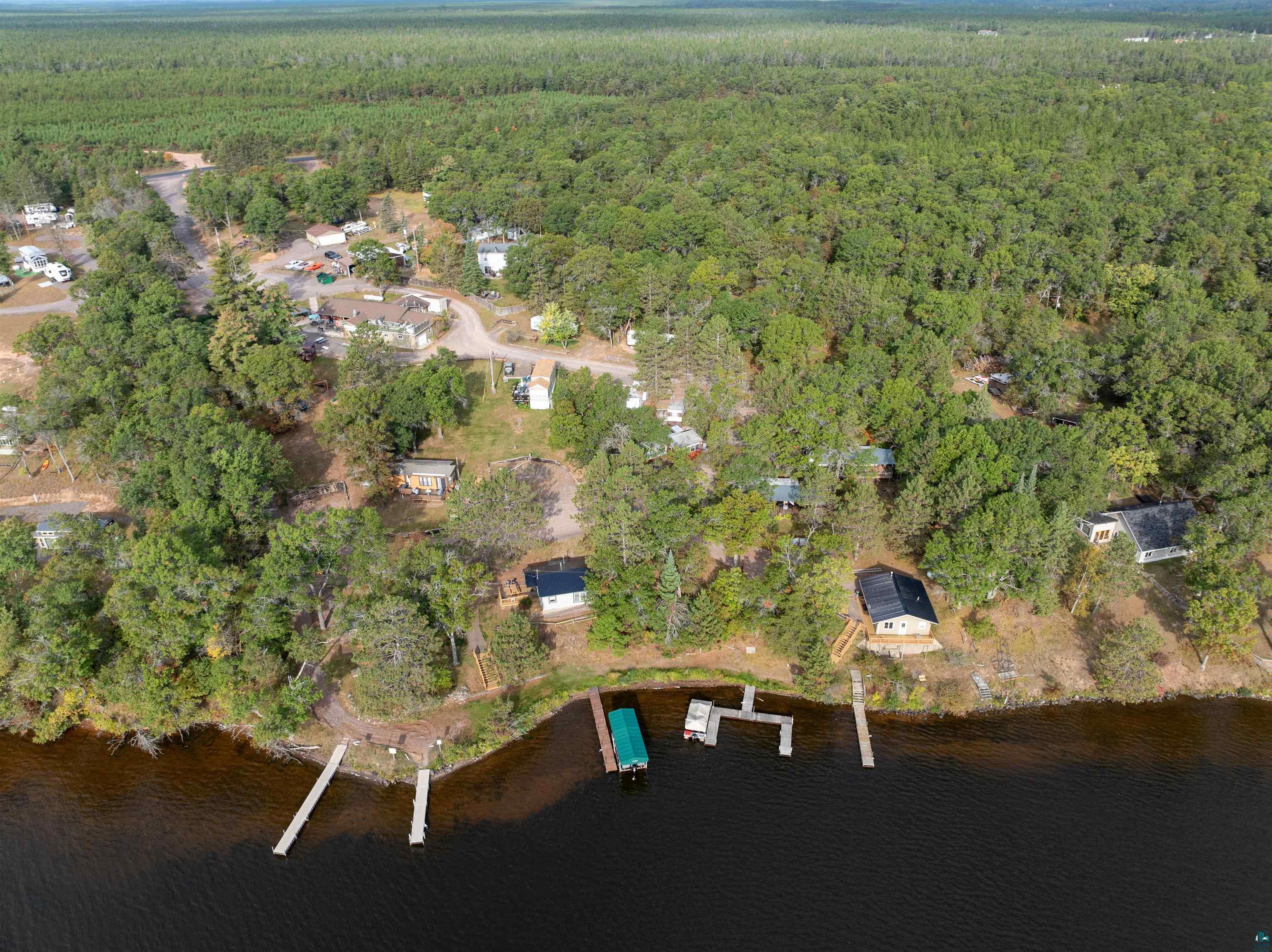 6833 View Point Lodge Road, Unit 14 Gordon, WI 54838 - Photo 28 of 34 Bird's eye view of a forest and a nearby body of water