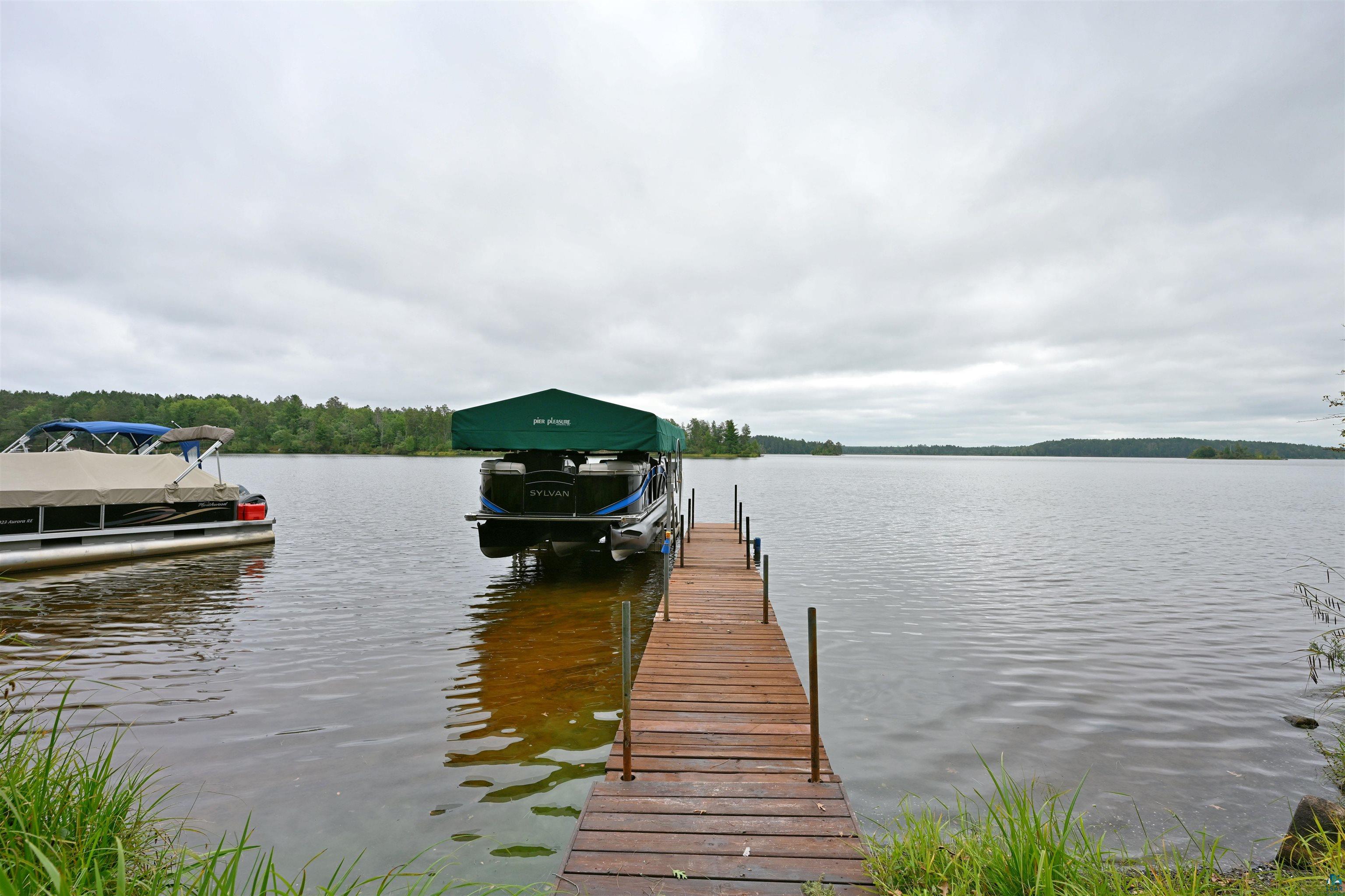 6833 View Point Lodge Road, Unit 14 Gordon, WI 54838 - Photo 6 of 34 Dock featuring boat lift and a water view