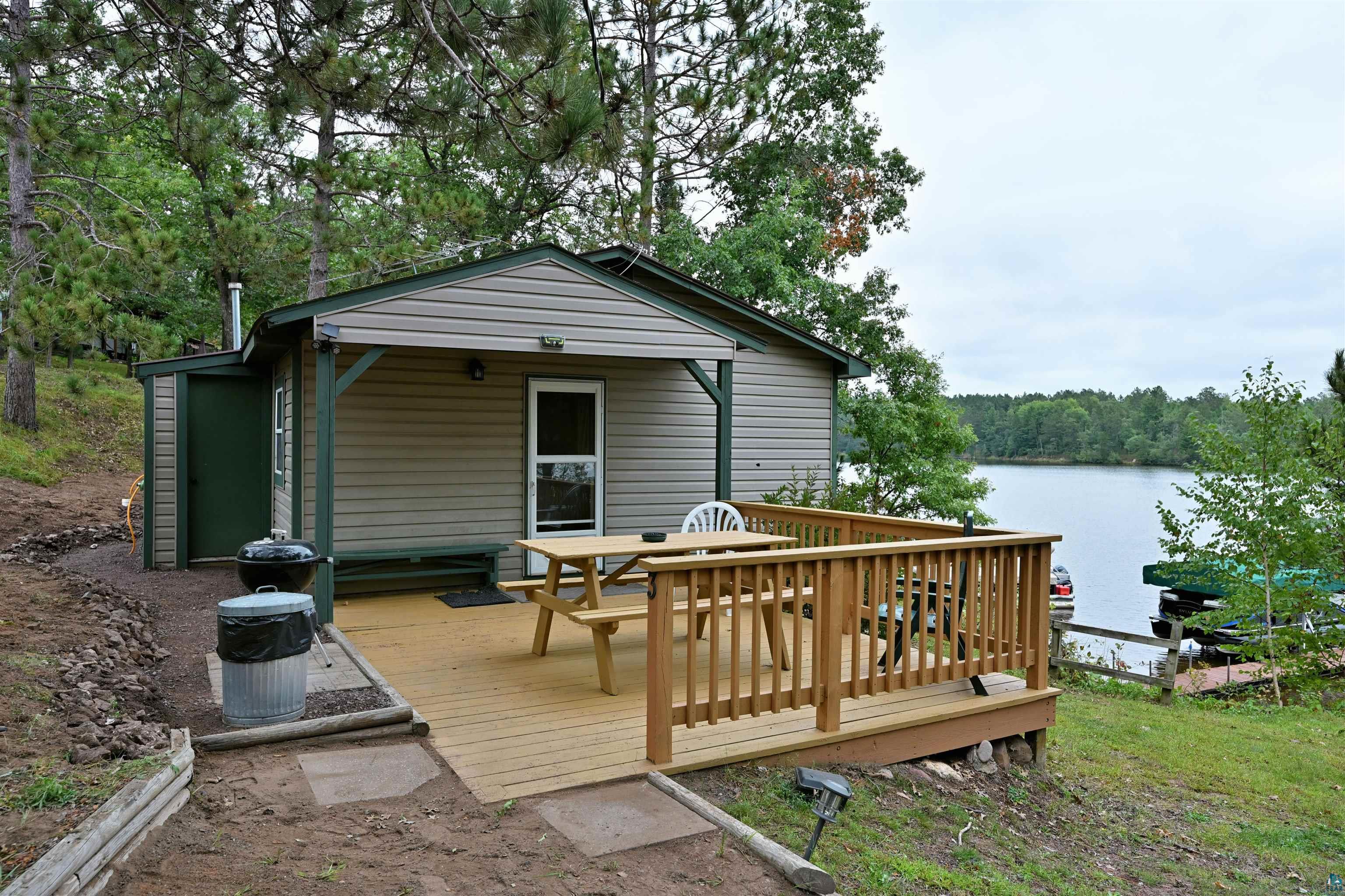 6833 View Point Lodge Road, Unit 14 Gordon, WI 54838 - Photo 9 of 34 Deck featuring outdoor dining space and a water view