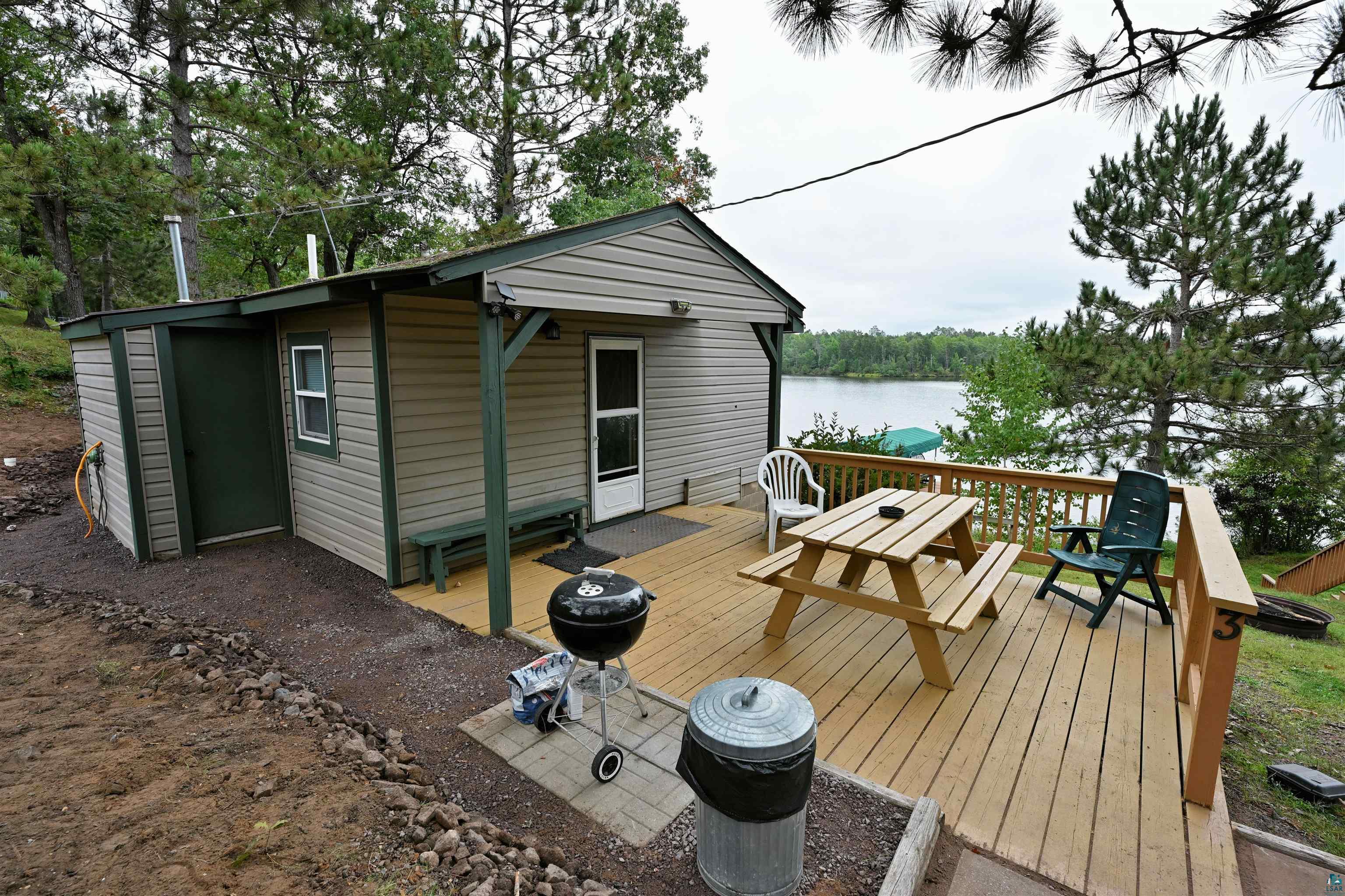 6833 View Point Lodge Road, Unit 14 Gordon, WI 54838 - Photo 10 of 34 Wooden terrace with a water view, an outdoor structure, and area for grilling