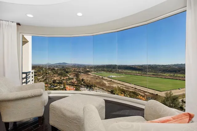 a bedroom with a bed and large window