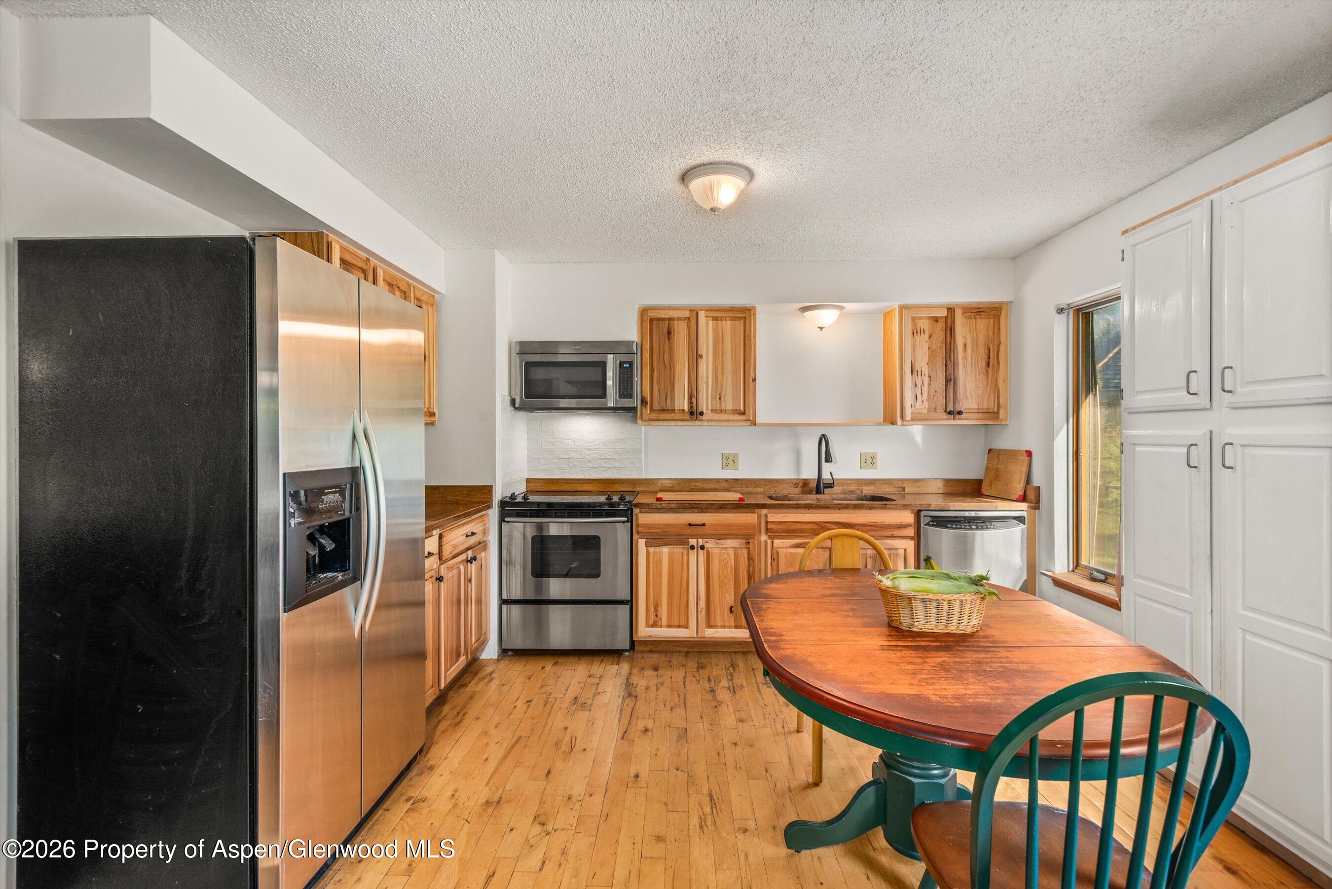 198 Holland Hills Road Basalt, CO 81621 - Photo 21 of 50 a kitchen with stainless steel appliances granite countertop a refrigerator a sink a stove and island