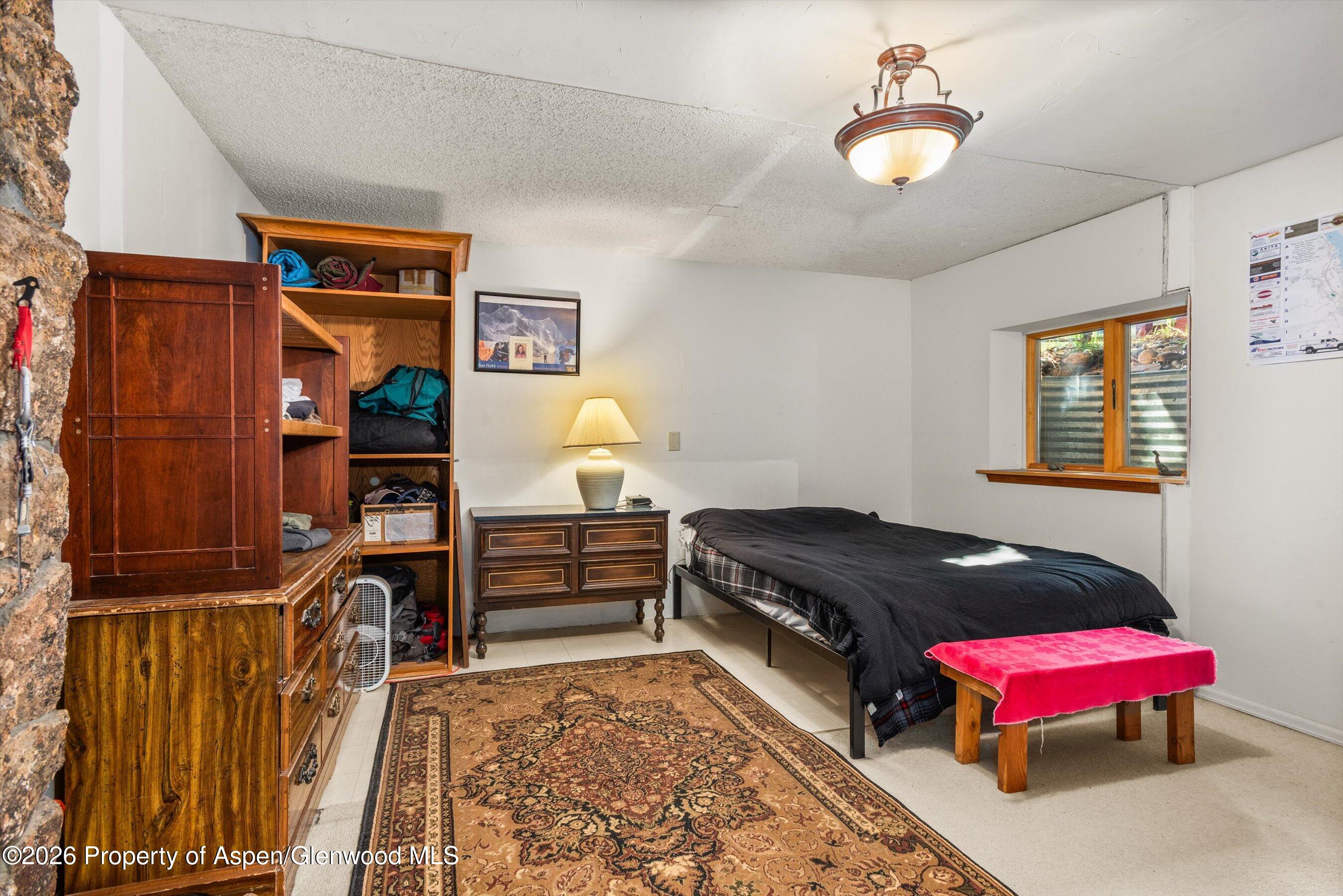 198 Holland Hills Road Basalt, CO 81621 - Photo 23 of 50 a bedroom with furniture and a window