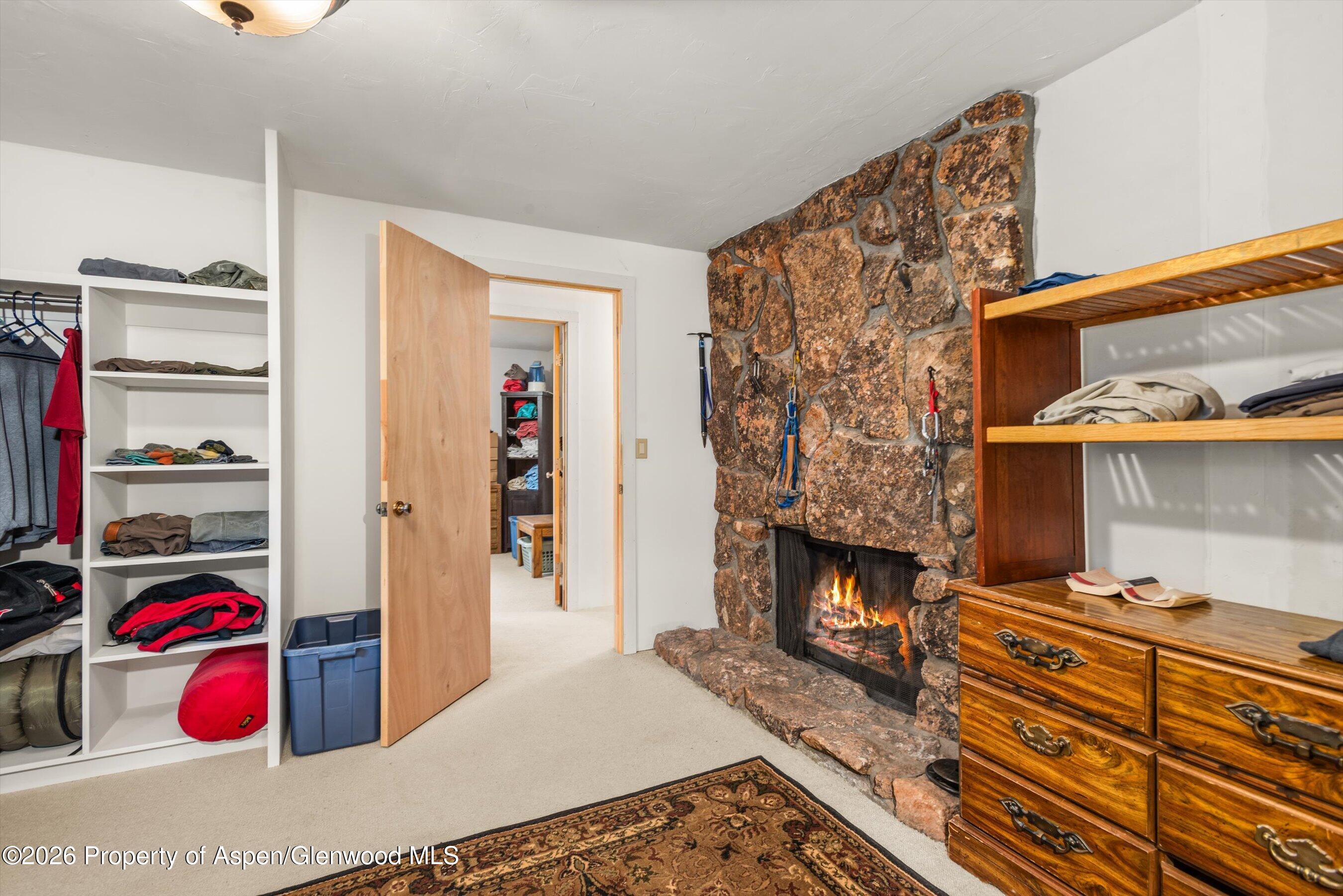 198 Holland Hills Road Basalt, CO 81621 - Photo 24 of 50 a bedroom with a bed and a fireplace