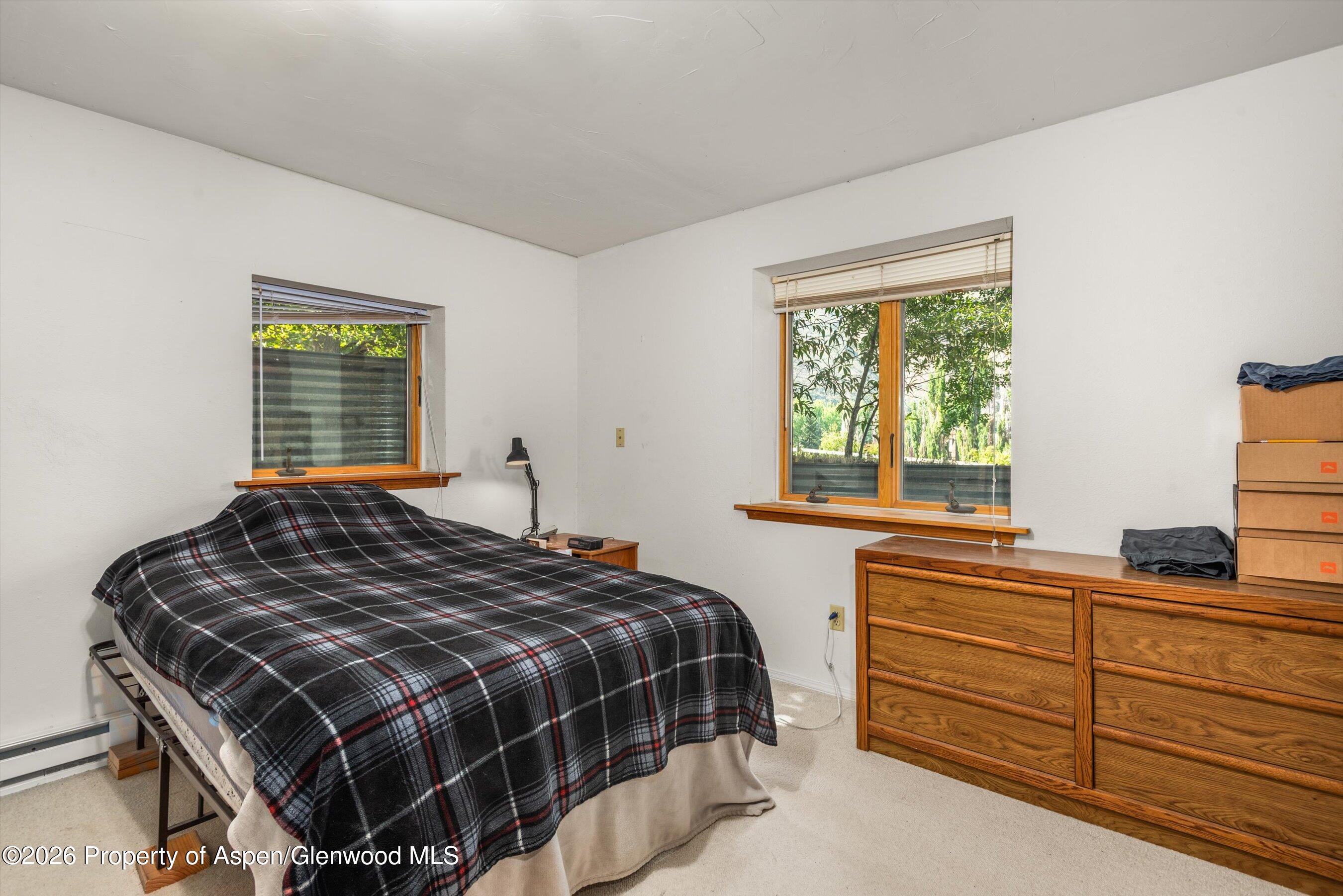 198 Holland Hills Road Basalt, CO 81621 - Photo 25 of 50 a bedroom with a bed and a window