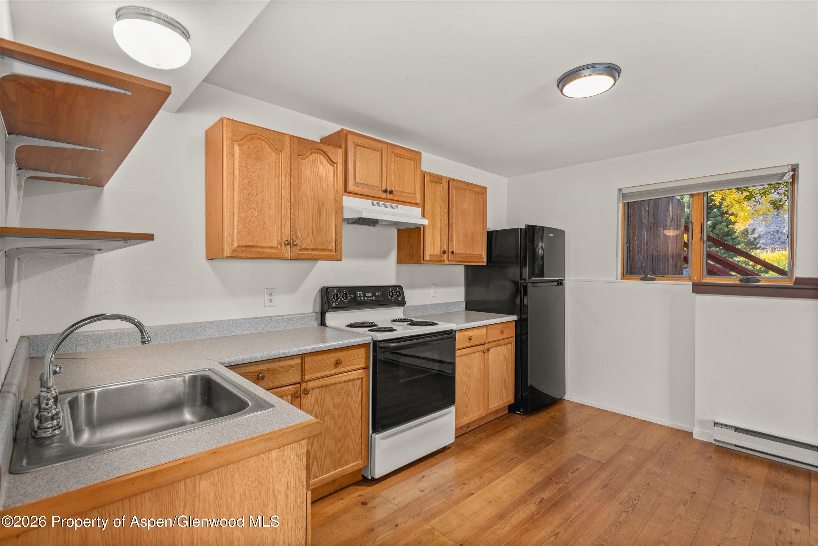 198 Holland Hills Road Basalt, CO 81621 - Photo 33 of 50 a kitchen with stainless steel appliances granite countertop a sink stove and refrigerator