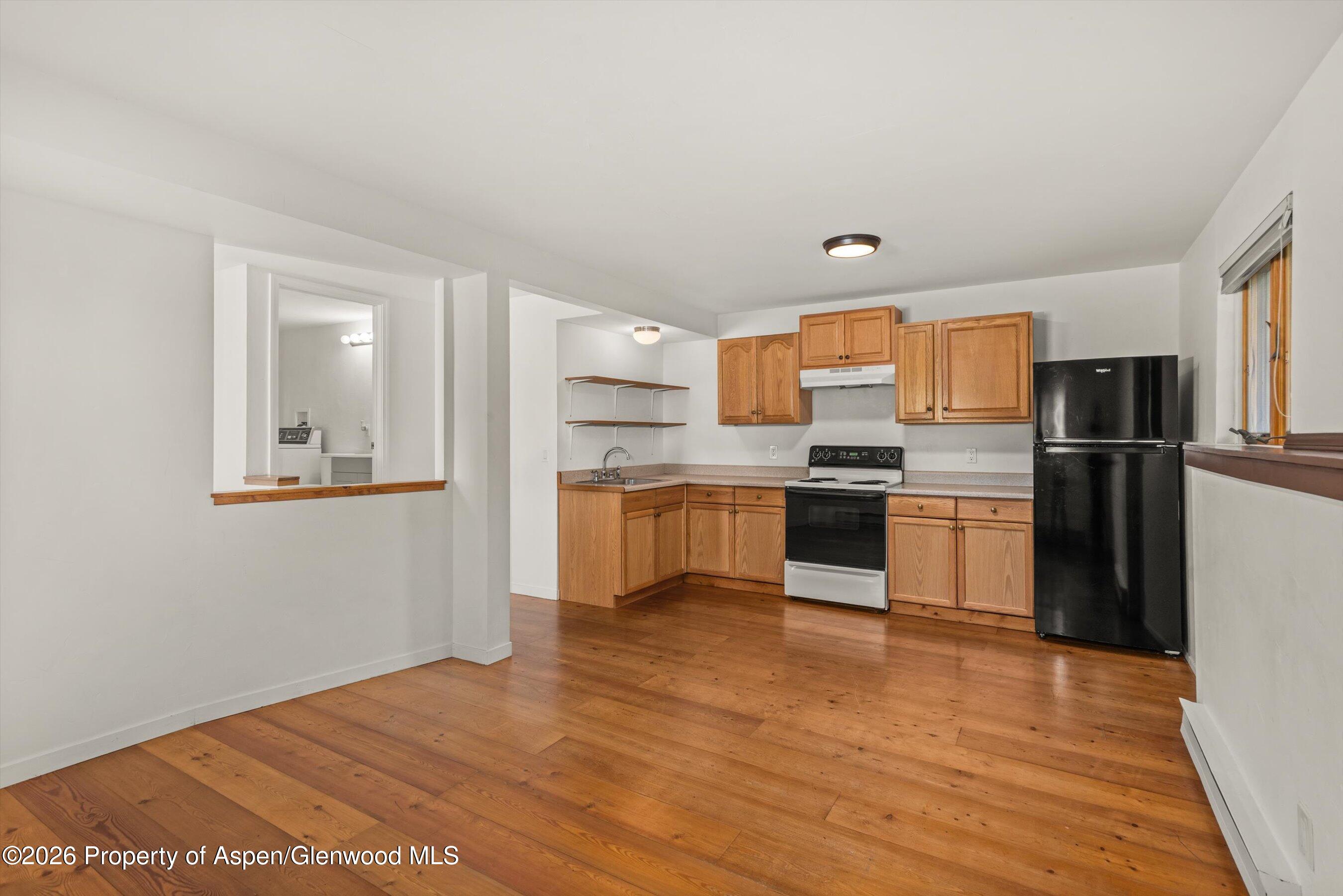 198 Holland Hills Road Basalt, CO 81621 - Photo 34 of 50 a kitchen with granite countertop a refrigerator and wooden floor