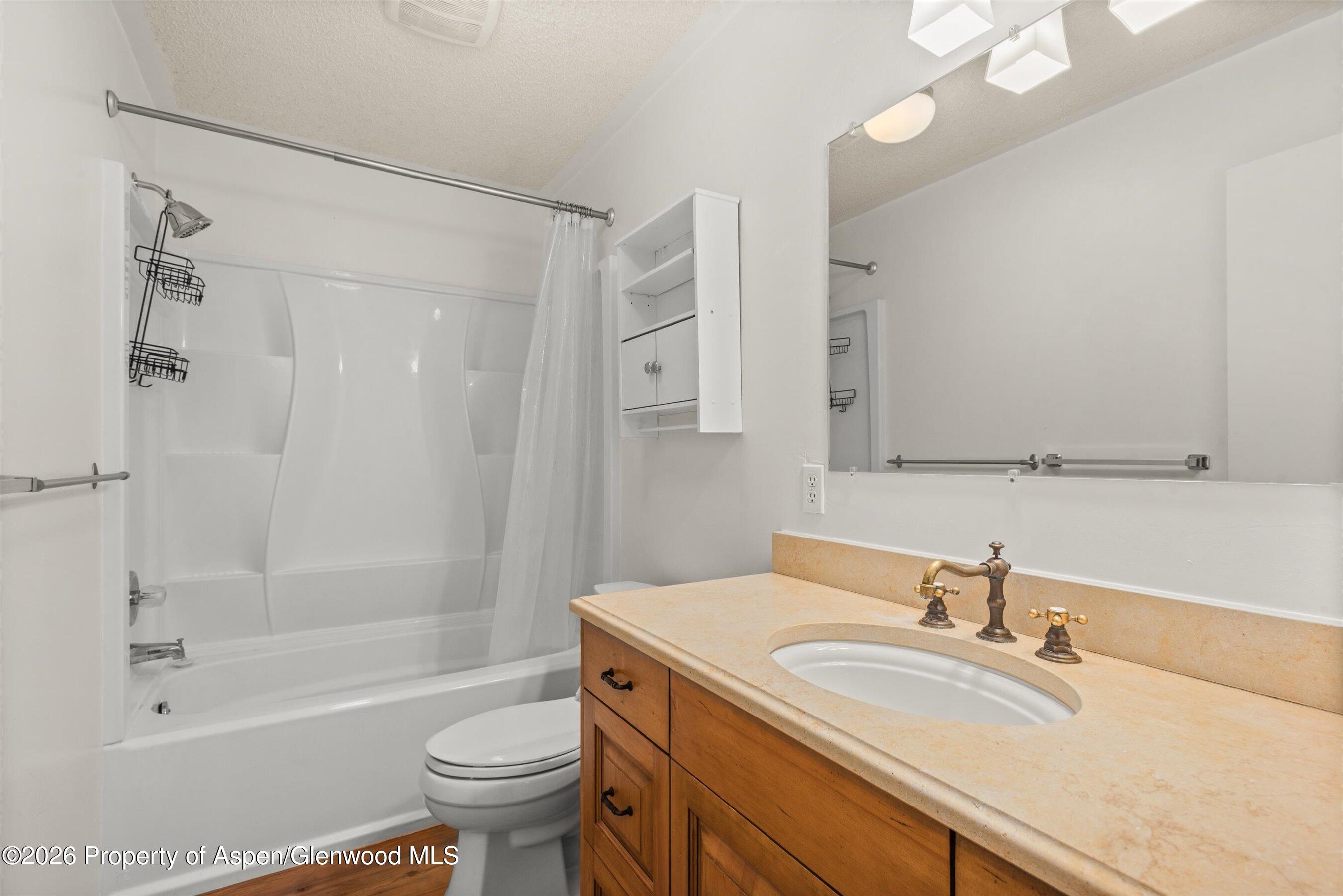 198 Holland Hills Road Basalt, CO 81621 - Photo 40 of 50 a bathroom with a granite countertop sink a toilet and a bathtub