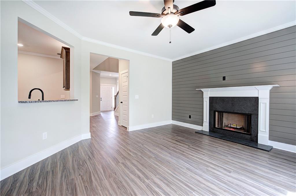 266 Summit Height Drive Cartersville, GA 30121 - Photo 12 of 51 a view of an empty room with wooden floor and a fireplace