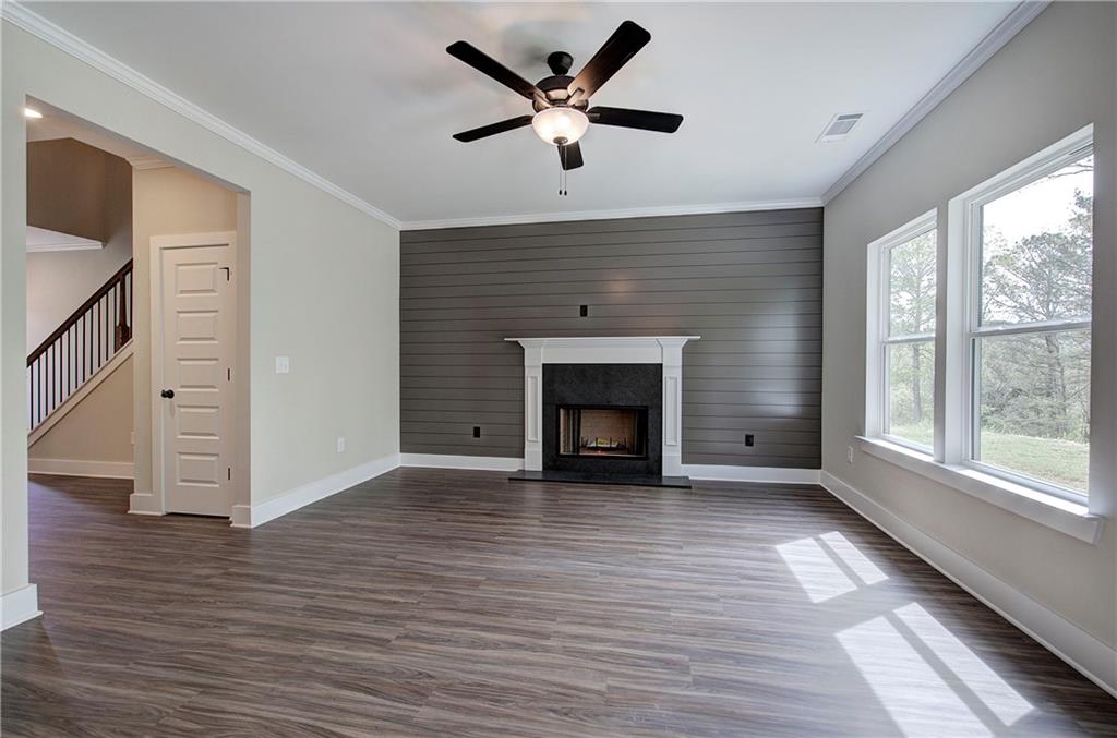 266 Summit Height Drive Cartersville, GA 30121 - Photo 13 of 51 a view of an empty room with wooden floor and a fireplace