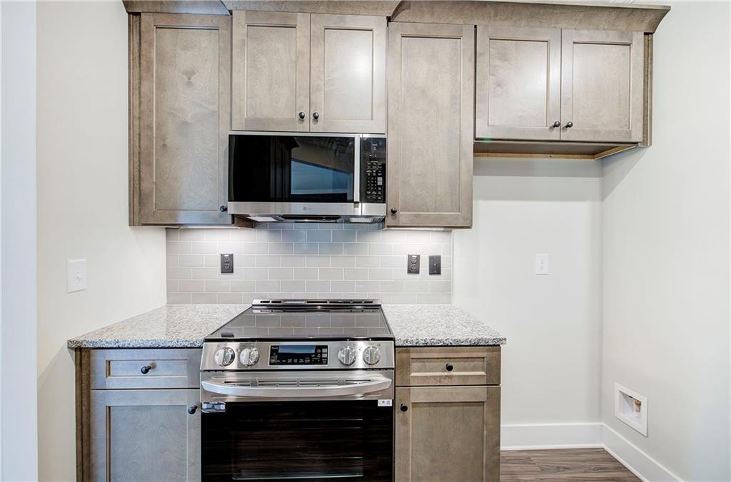 266 Summit Height Drive Cartersville, GA 30121 - Photo 17 of 51 a kitchen with stainless steel appliances granite countertop a stove and a microwave