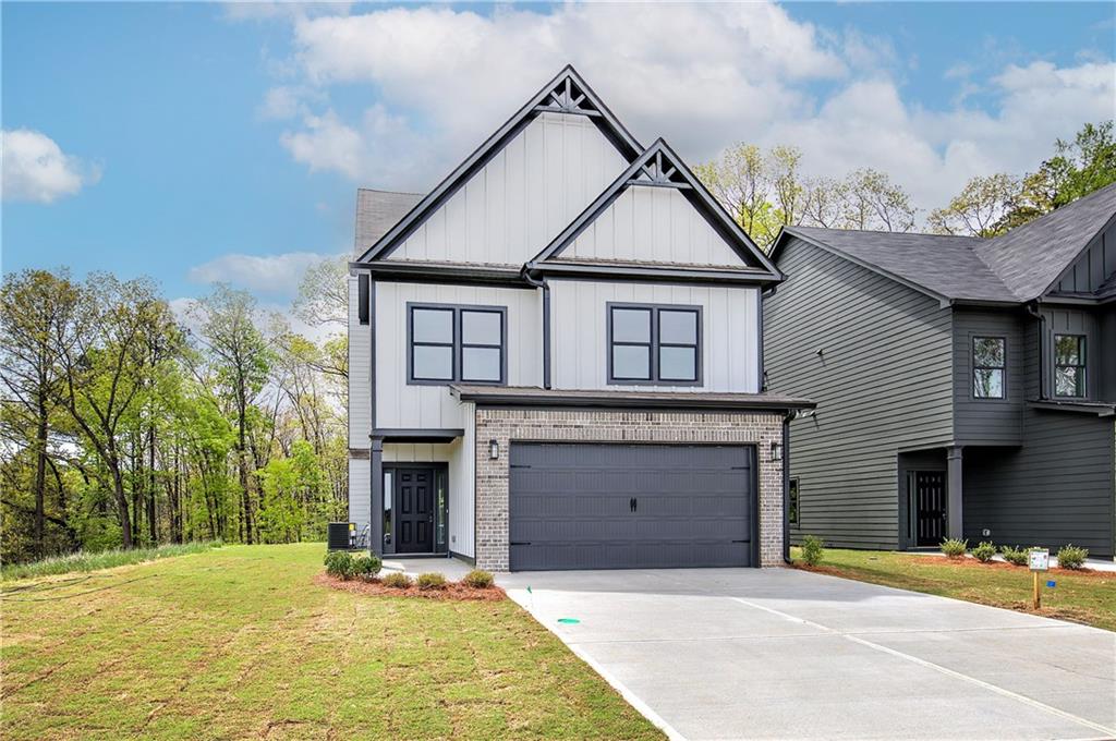 266 Summit Height Drive Cartersville, GA 30121 - Photo 2 of 51 a front view of a house with a yard and garage